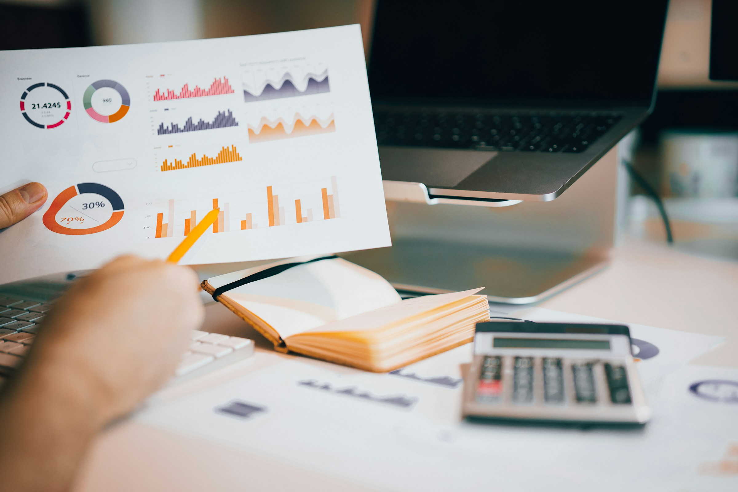 A person pointing at a chart and data