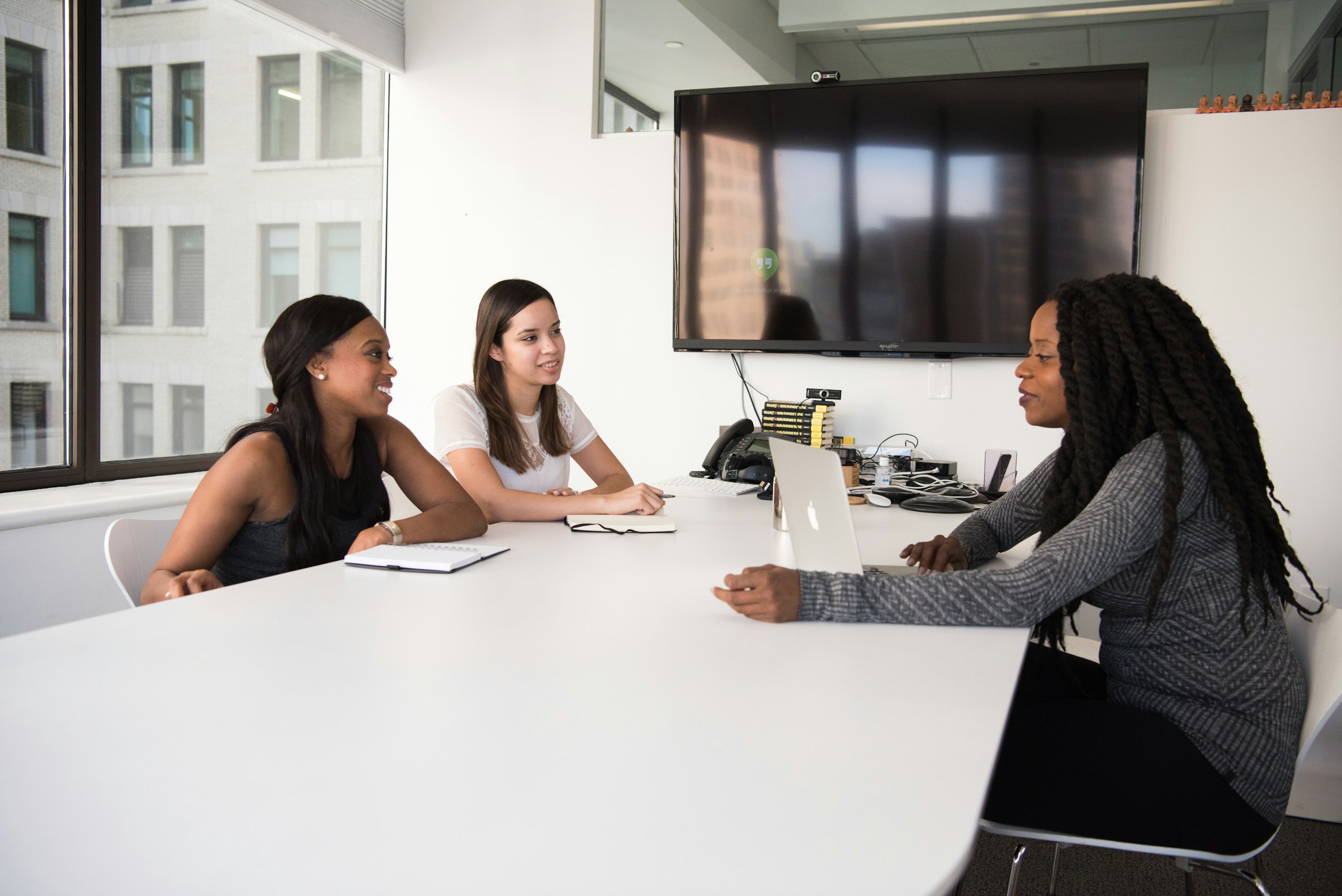3 people in a meeting room